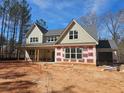 New home exterior with visible construction details and modern window designs at 6841 Phillips Mill Rd, Douglasville, GA 30135