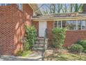 Inviting entrance with stone stairs and a secure metal door at 195 Hermer Nw Cir, Atlanta, GA 30311