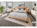 Modern bedroom featuring a platform bed, stylish furniture, and bright natural light at 2470 Bridle Bridge Trl, Cumming, GA 30040