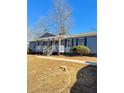 Charming single-story home with a welcoming front porch, walkway, and well-maintained landscaping at 383 Third Ave, Scottdale, GA 30079