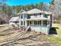 Charming two-story home featuring a spacious porch, beautiful windows, and an attached three car garage at 4130 Plunkett Rd, Lithonia, GA 30038