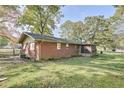 Backyard featuring well-kept grass and a brick exterior at 1189 E East Fayetteville Rd, Riverdale, GA 30296