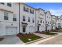 Row of townhomes featuring garages, multiple windows, and landscaped front yards at 3135 Washburn St, Atlanta, GA 30354