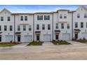 New townhomes with white exteriors, black trim, garages, and small landscaped yards at 3135 Washburn St, Atlanta, GA 30354