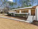 Charming white brick home featuring a neatly landscaped front entrance at 4562 Anderson Livsey Ln, Snellville, GA 30039