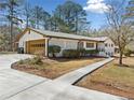 Single-story home boasts an attached garage and well-maintained landscaping at 4562 Anderson Livsey Ln, Snellville, GA 30039