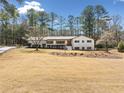 Inviting single-story home with a well-manicured lawn and mature trees at 4562 Anderson Livsey Ln, Snellville, GA 30039