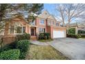 Charming two-story brick home with attached two-car garage and well-manicured landscaping at 5071 Vinings Estates Se Ct, Mableton, GA 30126