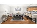 Dining area with seating for six, stylish light fixture, and breakfast bar overlooking the kitchen at 106 Brighton Pt, Atlanta, GA 30328