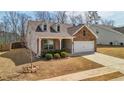 Cozy brick home with a well-kept lawn and a convenient two-car garage at 158 Rolling Hills Pl, Canton, GA 30114