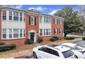 Brick townhouse featuring black shutters and well maintained landscaping at 2345 Henderson Mill Ne Rd # 1, Atlanta, GA 30345