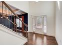 Bright, two-story foyer with hardwood floors, staircase, and views to formal dining at 3483 Summerlin Pkwy, Lithia Springs, GA 30122