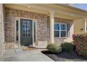 Close-up of front door with decorative brickwork and manicured landscaping at 3483 Summerlin Pkwy, Lithia Springs, GA 30122