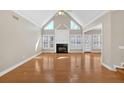 Bright living room with hardwood floors, fireplace, vaulted ceiling, and lots of natural light at 2021 Cockrell Pointe Nw, Kennesaw, GA 30152