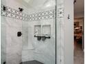 Modern shower featuring elegant tile work, a built-in niche, and sleek fixtures, creating a spa-like experience at 120 Mill Creek Ct, Acworth, GA 30101