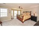 Spacious main bedroom featuring plush carpeting, abundant natural light, and a ceiling fan for added comfort at 120 Mill Creek Ct, Acworth, GA 30101