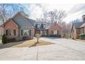 Charming brick home with a well-manicured lawn, mature trees and inviting curb appeal at 1765 Dew Pl, Marietta, GA 30064