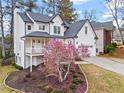 Beautifully landscaped front yard featuring a flowering magnolia tree and a charming two-story home at 303 Valley Green Ct, Woodstock, GA 30189