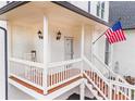 Quaint front porch with classic railing and sconce lighting at 303 Valley Green Ct, Woodstock, GA 30189