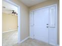 Inviting foyer with tile floors, a white front door, and an open view into the living space at 509 Carrington Ct, Canton, GA 30115