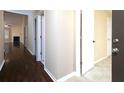 Hallway with hardwood floors and view into the living room featuring a fireplace at 509 Carrington Ct, Canton, GA 30115