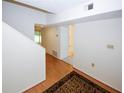 Bright entryway with wood flooring and an area rug, leading to the upper level of the home at 165 Woodhaven Way, Alpharetta, GA 30009