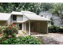 Home exterior featuring a carport, beautiful plants, and neutral siding for a peaceful setting at 165 Woodhaven Way, Alpharetta, GA 30009