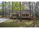 Quaint cottage-style home with a wooden porch, perfect for enjoying the wooded surroundings at 98 Brenda Cir, Rockmart, GA 30153