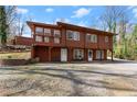Two-story home with natural landscaping, offering inviting entrance at 2655 Lakeside Trl, Cumming, GA 30041