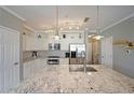 The white kitchen features granite countertops, subway tile backsplash, and stainless steel appliances at 4805 W Village Se Way # 1302, Smyrna, GA 30080