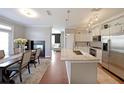 Open-concept layout with a fireplace, dining area, and kitchen featuring an island with granite countertops at 4805 W Village Se Way # 1302, Smyrna, GA 30080