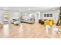 Bright living room with neutral tones, wood floors, and ample seating at 6828 Lockridge Dr, Atlanta, GA 30360