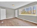 Living room has wood floors and a large window that provides plenty of natural light at 1883 Clarke Ln, Decatur, GA 30035