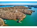 Breathtaking aerial view of a home site and private boat dock on a tranquil lake surrounded by nature at 4595 Ryker Rd, Cumming, GA 30041
