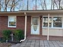 Charming single-story brick home featuring a welcoming front door and well-maintained landscaping at 877 Verona Dr, Clarkston, GA 30021