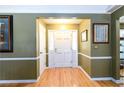 Welcoming foyer with hardwood floors, paneled walls, and a bright front door at 2272 Kimberley Way, Snellville, GA 30078