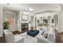 Elegant living room featuring a fireplace, hardwood floors, and large bay windows with lots of natural light at 5321 Whitehaven Park Se Ln, Smyrna, GA 30082