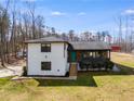 Beautiful two-story house featuring a charming front porch, stone accents, and lush landscaping that enhances curb appeal at 118 Raven Rd, Villa Rica, GA 30180