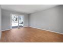 Bright bedroom featuring neutral walls, wood floors, and a sliding glass door to the outside at 2522 Brentwood Ct, Decatur, GA 30032