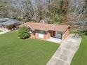 Aerial view of brick home with a well-kept lawn and a long driveway at 2522 Brentwood Ct, Decatur, GA 30032