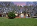 Charming single-story brick home featuring a well-manicured lawn and mature trees at 2522 Brentwood Ct, Decatur, GA 30032