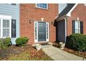 Close-up view of the brick and siding facade of the two-story home with a front door at 3820 Mast Nw Ct, Kennesaw, GA 30144