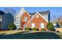 Traditional two-story home featuring brick and siding exterior, framed by a green lawn and mature trees at 3820 Mast Nw Ct, Kennesaw, GA 30144
