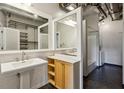 Modern bathroom with exposed pipes, walk in shower, dual mirrors, and pedestal sink at 878 Peachtree # 522, Atlanta, GA 30309