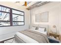 Bright bedroom featuring a large window, minimalist décor, and a comfortable-looking bed at 878 Peachtree # 522, Atlanta, GA 30309