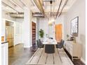 Dining room with modern lighting fixture, sleek furniture, and wood accent wall at 878 Peachtree # 522, Atlanta, GA 30309