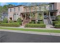 Brick townhomes featuring manicured landscaping, inviting front porches, and a well-maintained facade at 3123 Neal Ct, Cumming, GA 30041