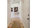 Hallway with hardwood flooring and modern artwork for a cozy and artistic entry to the home at 1430 Dresden Ne Dr # 200, Atlanta, GA 30319