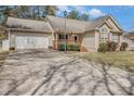 Inviting ranch-style home with a long driveway, an attached garage and covered porch at 170 Double D Rd, Temple, GA 30179