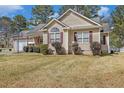 A charming ranch home with symmetrical windows, neutral siding, and neatly trimmed shrubs enhances its curb appeal at 170 Double D Rd, Temple, GA 30179